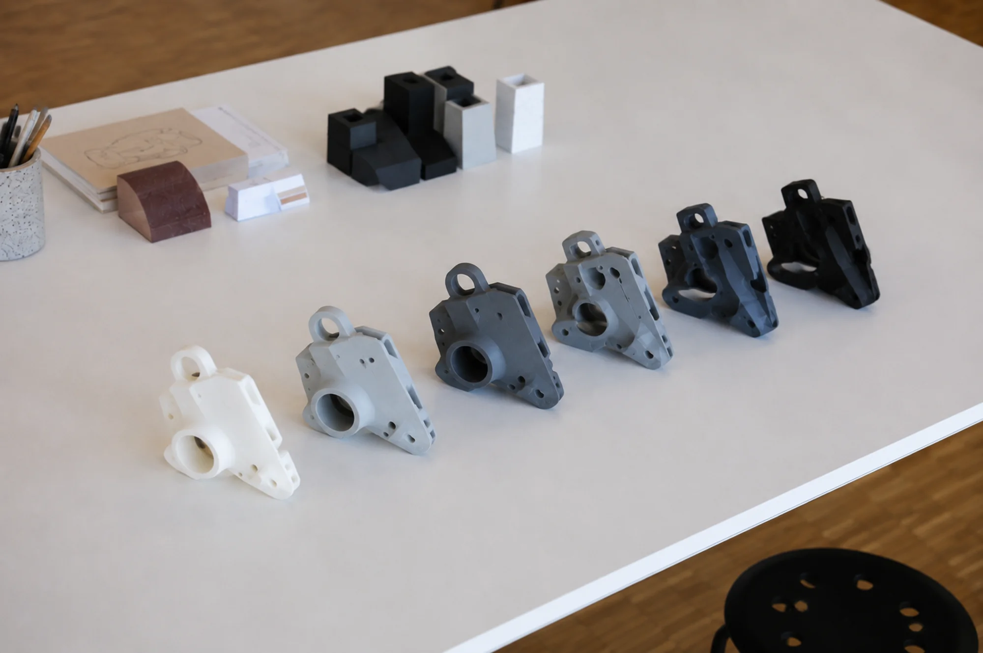 Várias versões do mesmo suporte impressas em 3D, da primeira tentativa à peça final